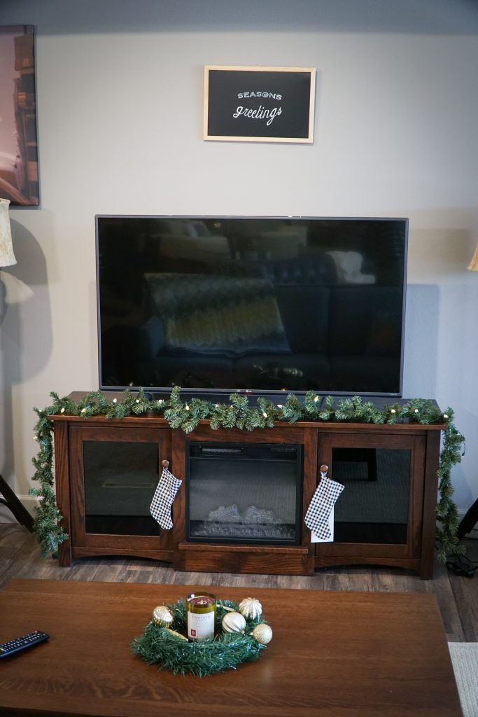 Flint Electric Fireplace with garland, stockings, and season's greeting chalkboard 